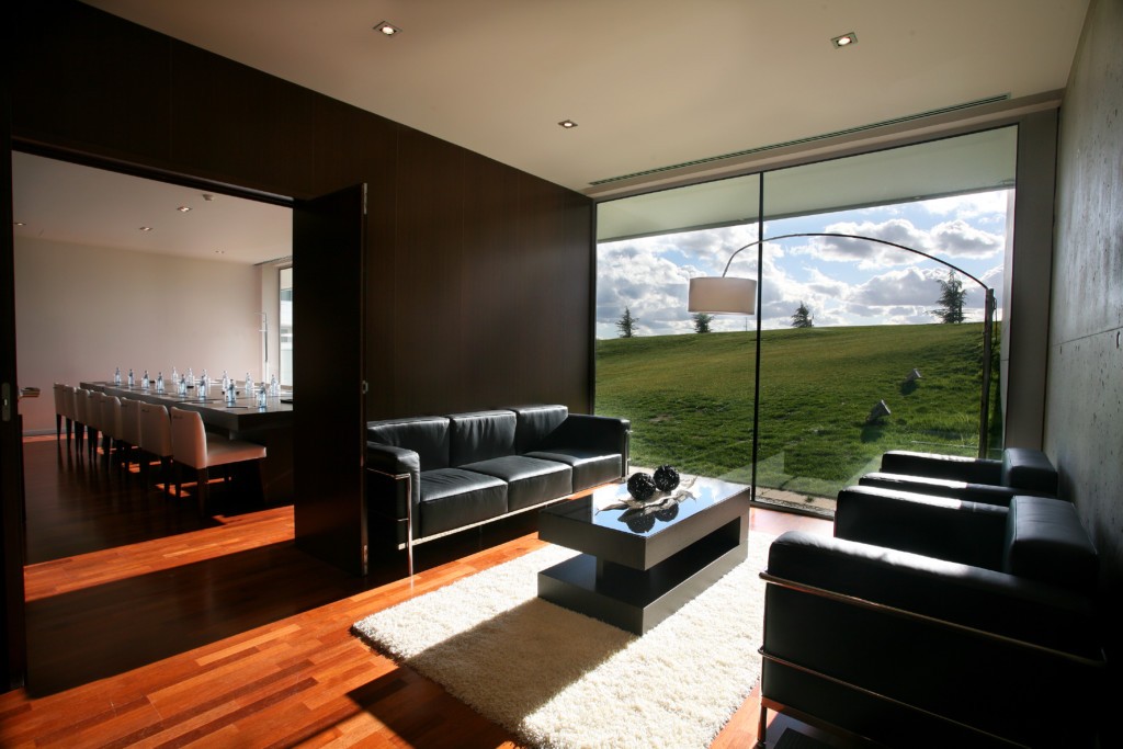 Exclusive meeting room in the finca prats hotel with a great view on the golf course and a meeting table full of pineo water